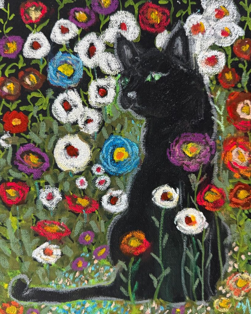 Black Cat surrounded by flowers